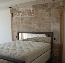 Kronos limestone cladding on the back wall of a master bedroom headboard