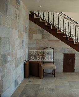 kronos limestone cladding used on the foyer entry wall and main staircase of an Italian style Villa