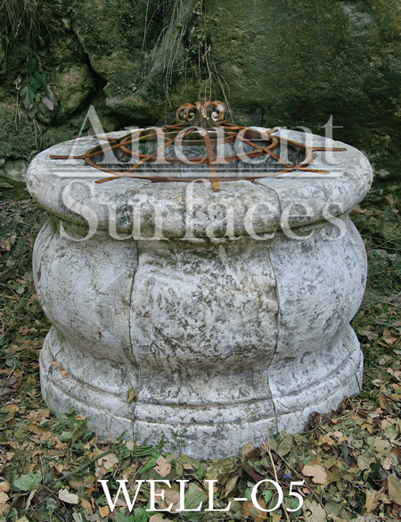 Ancient tea pot shaped reclaimed stone well head with old hand twisted metal work