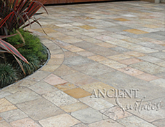 Ancient Reclaimed 'Arcane Stone' pavers salvaged from 17th century era homes, villas and farmhouses from sleepy southern European towns and villages. In this picture this limestone is shown installed on a driveway and in the garage of this coastal Mediterranean home. The Arcane Stone is perfect for all types of external and internal weather conditions and traffic volumes.