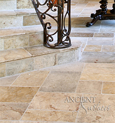 Antique reclaimed 'Arcan Stone' flooring pavers installed although this French countryside style home