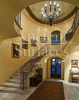kronos limestone used on the foyer entry and main staircase of a home
