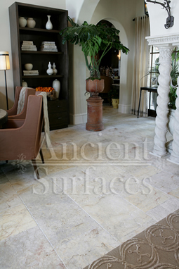 Millenium Limestone flooring wide planks installed in a living room and foyer of a mediterranean style coastal beach villa