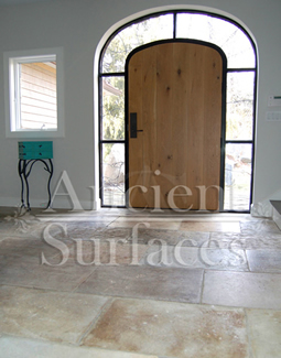 Millenium Limestone flooring wide planks installed in the entryway of a mediterranean style coastal beach villa