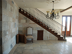 Millennium Limestone flooring wide planks installed in the livingroom of a Mediterranean style coastal beach villa.