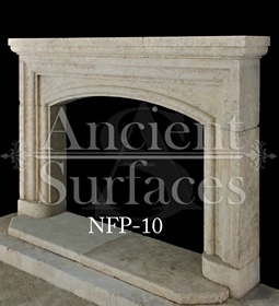 An arched stone fireplace surround carved by hand