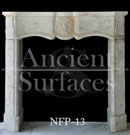 A very beautiful and simple Louis XV fireplace mantel hand carved with stone and carries many curvatures and features a nice middle motif finished with a convex leg profile