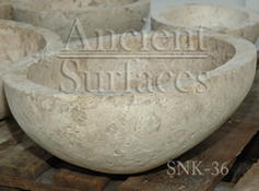 Half egg shaped limestone sink hand carved out of an antique limestone block