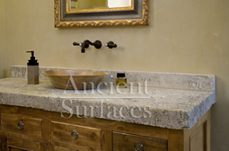 Antique thick Limestone slabs milled at 3" in thickness used as vanity counter tops in a master bathroom, salvaged from the bottom of farm house foundations