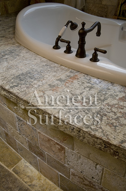 Antique thick Limestone slabs milled at 3" in thickness used as a bath tub surround in a master bathroom, salvaged from the bottom of farm house foundations