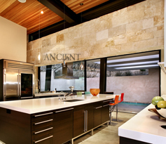 Mesa limestone cladding used on the foyer entry wall and main staircase of an Italian style Villa