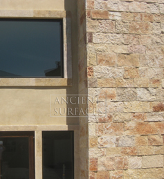 Mesa limestone cladding on the back wall of a master bedroom headboard