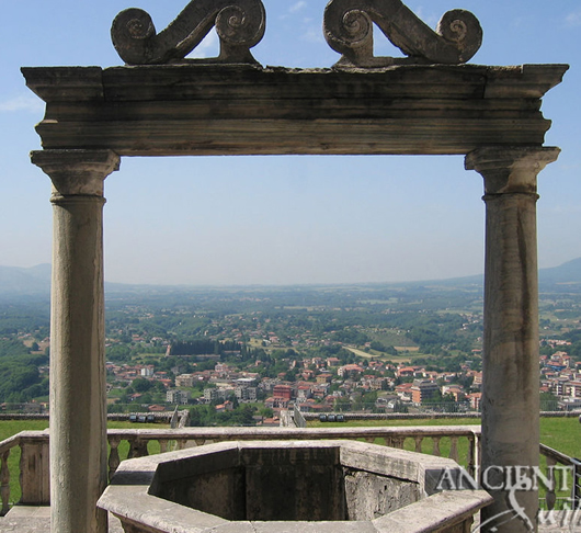 Anceint reclaimed limestone well with rosette motifs on its 4 faces salvaged from Italy topped with old hand twisted metal work