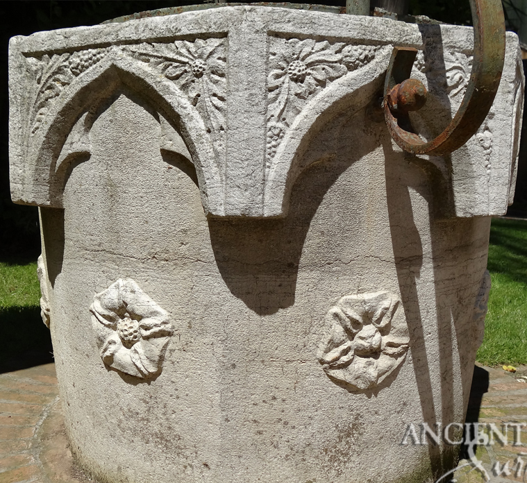 Anceint reclaimed limestone well with rosette motifs on its 4 faces salvaged from Italy topped with old hand twisted metal work