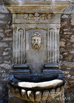 Antique stone wall fountain salvaged from the island of Corsica