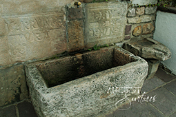 Ancient faucet and wash basin mounted into antique kronos limestone wall stone from the 16th century reclaimed from the south of France