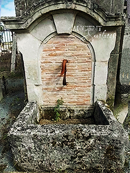 Ancient Reclaimed Stone Wall Fountain with an Angel Cherub Baby Face carved into the back of the fountain. Provenance, the south of France available in stock