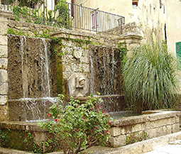 A beautiful 17th century antique reclaimed limestone wall fountain salvaged from the south of France