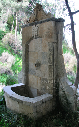 An antique limestone wall fountain with a medusa head mask reclaimed from Northern Europe circa 18th century