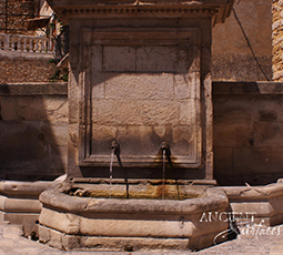 A beautiful 17th century antique reclaimed limestone wall fountain salvaged from the south of France