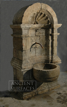 An antique limestone wall fountain with a medusa head mask reclaimed from Northern Europe circa 18th century