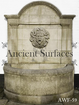 An antique limestone wall fountain with a medusa head mask reclaimed from Northern Europe circa 18th century