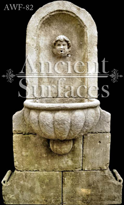 Ancient Reclaimed Stone Wall Fountain with an Angel Cherub Baby Face carved into the back of the fountain. Provenance, the south of France available in stock