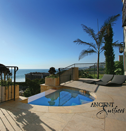 Millennium Limestone flooring wide planks installed in the livingroom of a Mediterranean style coastal beach villa.