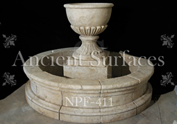 Hand carved rounded limestone pool fountain with urn