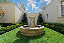 Hand carved rounded limestone pool fountain