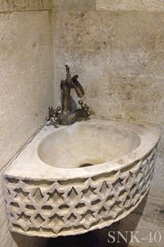 Antique reclaimed stone basin sink salvaged restored and installed in this traditional style Mediterranean home.